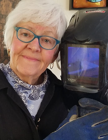 Carol Adamec with welding helmet