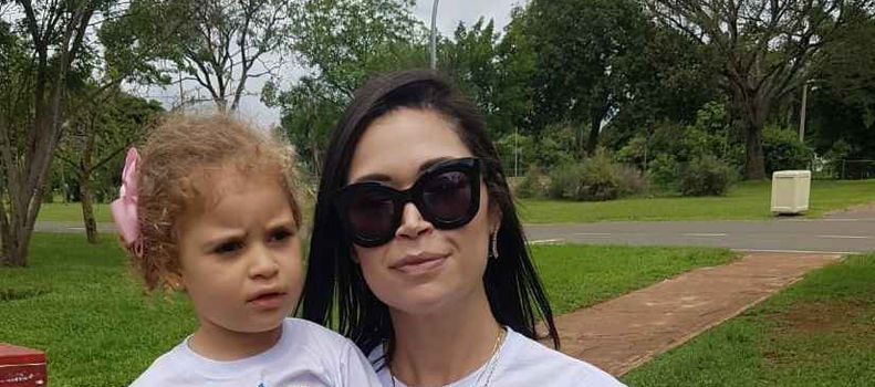 Foto de uma mulher com uma criança com Pitt Hopkins no colo