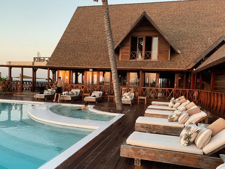 Luxury hotel poolside view with sun loungers, umbrellas, and eco-friendly hotel equipment designed for guest comfort and sustainability.