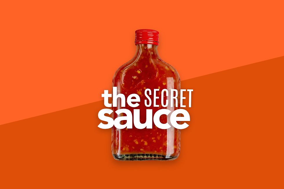 A close-up view of a red glass bottle featuring a white label with bold typography that reads "the SECRET sauce" against a vibrant orange background.