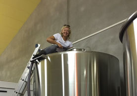 Sally pumping grapes into stainless steel vat