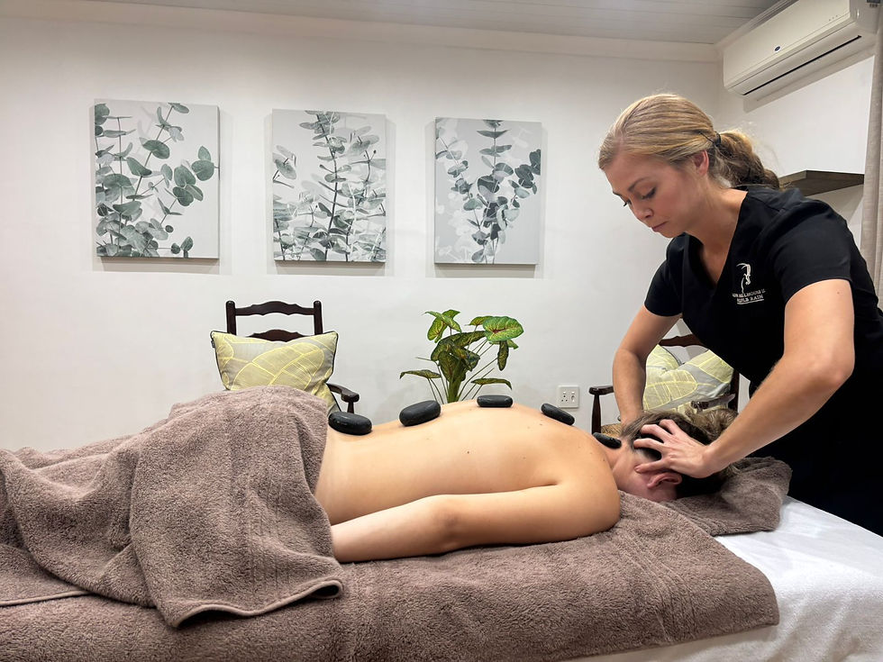 Guest having hot stone massage and relaxation treatment.jpg