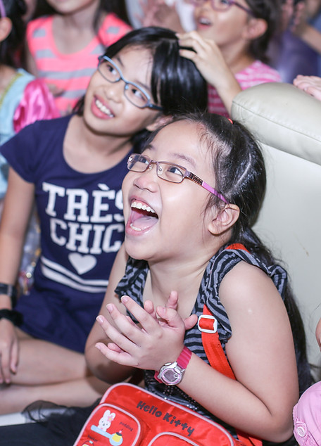 Girls laughing and amazed during a fun kids birthday magic show by Magic Of MarksonKids Party Magician Singapore | Magic Of Markson