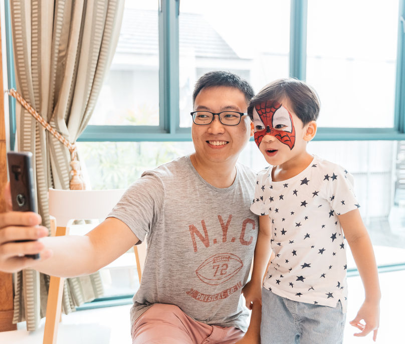 Father and child with superhero face paint at Magic Of Markson event.