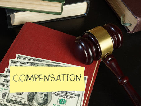 Gavel, Money, Compensation on a desk Image - No Workers’ Comp? Can I Still Sue My Employer? Harris County, TX Guide