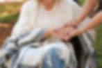 senior-woman-young-caregiver-holding-hands-outdoors-closeup.jpg