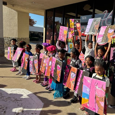 Group Photo of Kids posing with their finished paintings