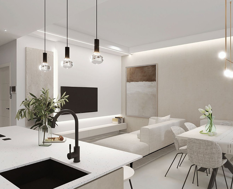 Vista angolare della cucina con isola centrale in primo piano, affacciata sull'area soggiorno-pranzo sullo sfondo. Un ambient