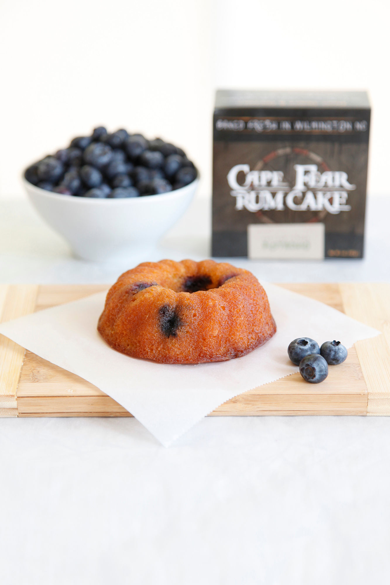 blueberry rum cake on cutting board