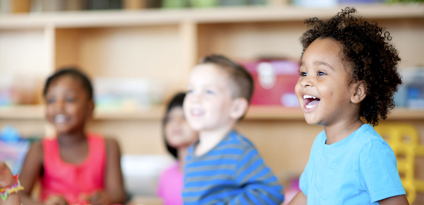 Group of preschoolers playing and laughing.