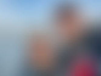 2 sailors in front of an arch