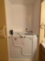 A bathtub shell in a bathroom with white walls