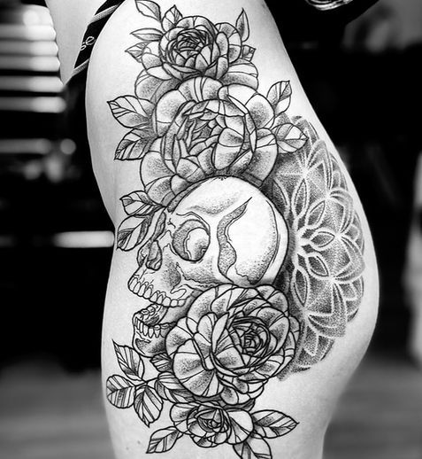 A black and white tattoo on the lower body