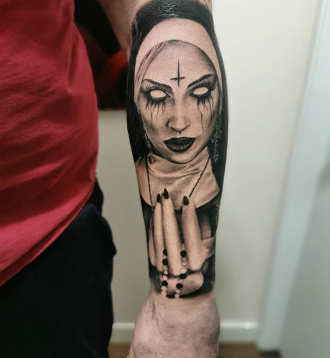 A scary tattoo of a nun.