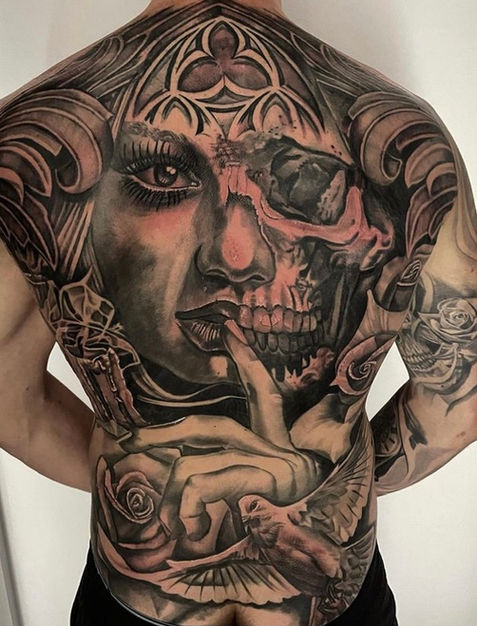 A boy flaunting a full back tattoo