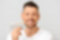 Man with teeth color samples on light background