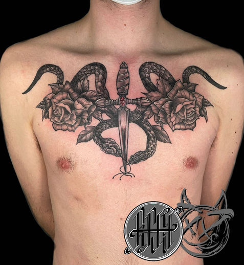 A tattoo of dagger and roses.