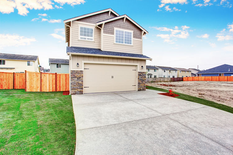 Concrete driveway leading to a garage on a residential property