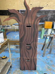Three blocks vertically stacked, making a tree. The top block has protruding branches, and no foliage.