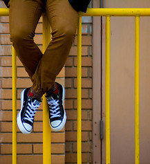 Person Sitting on Gate