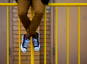 Person Sitting on Gate
