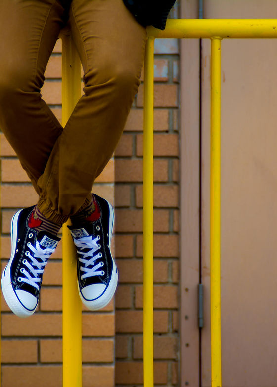 Person Sitting on Gate