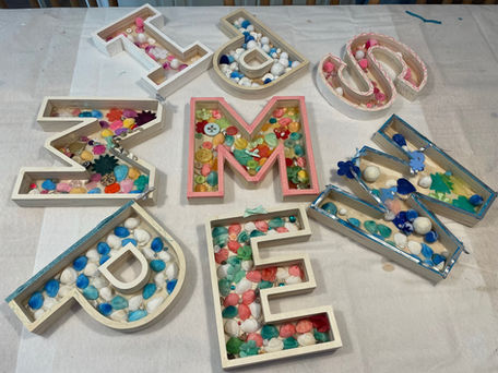 Colorful pom-pom filled wooden letters for parties