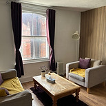 Cozy counselling room with chairs, table, and window Lisa Norfolk Counselling