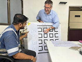 Andrew Fulton explaining mine structure to local client using whiteboard