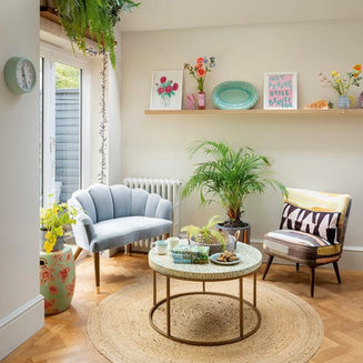 Modern sitting area with scalloped sofa and round rug at the Make space location home in chelmsford
