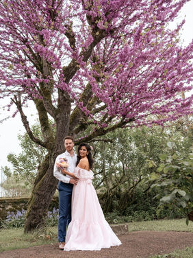 Bride and groom under a pink flowering tree