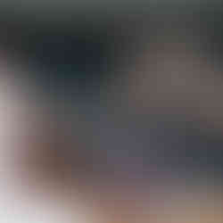 Woman speaks to a group of women in decorated living room setting.