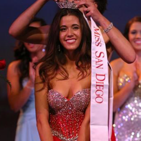 Woman crowned Miss San Diego, wearing beautiful red sparkly dress.