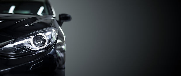 Black modern car closeup on black background._edited.jpg