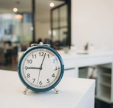 a-blue-alarm-clock-sits-on-a-white-desk-in-a-room-2025-03-15-01-55-00-utc.jpg