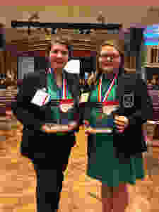 Gaines (L) and Agnew (R) show off their 1st place DECA glass trophies