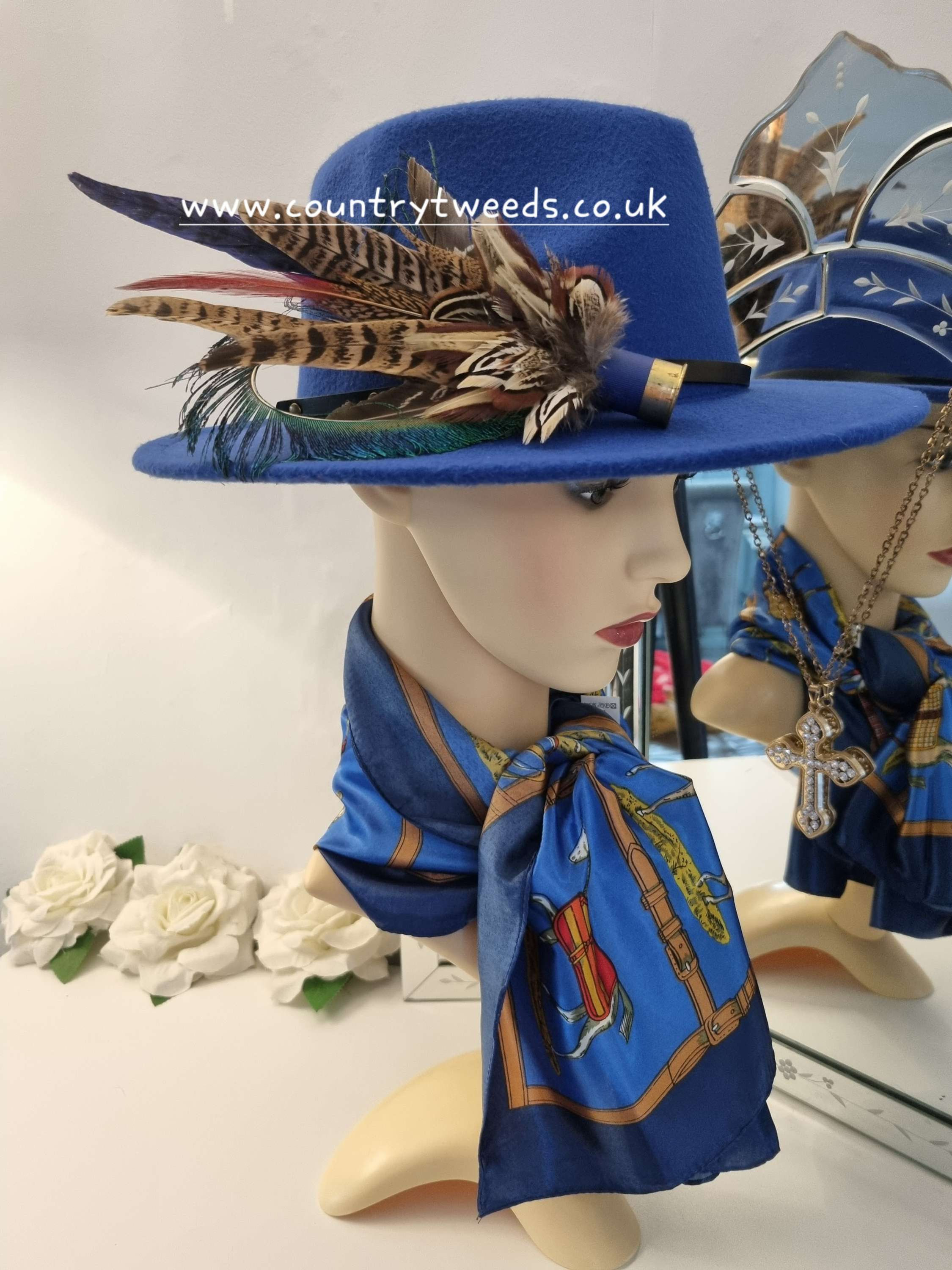 Royal blue fedora comes with this detachable feather brooch