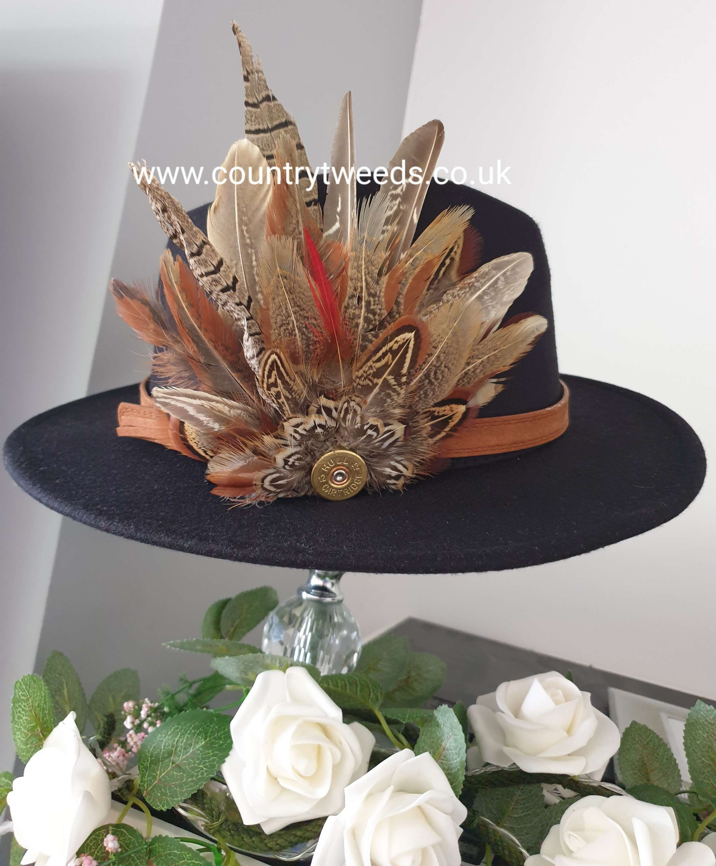 Black fedora hat comes with this stunning detachable feather brooch