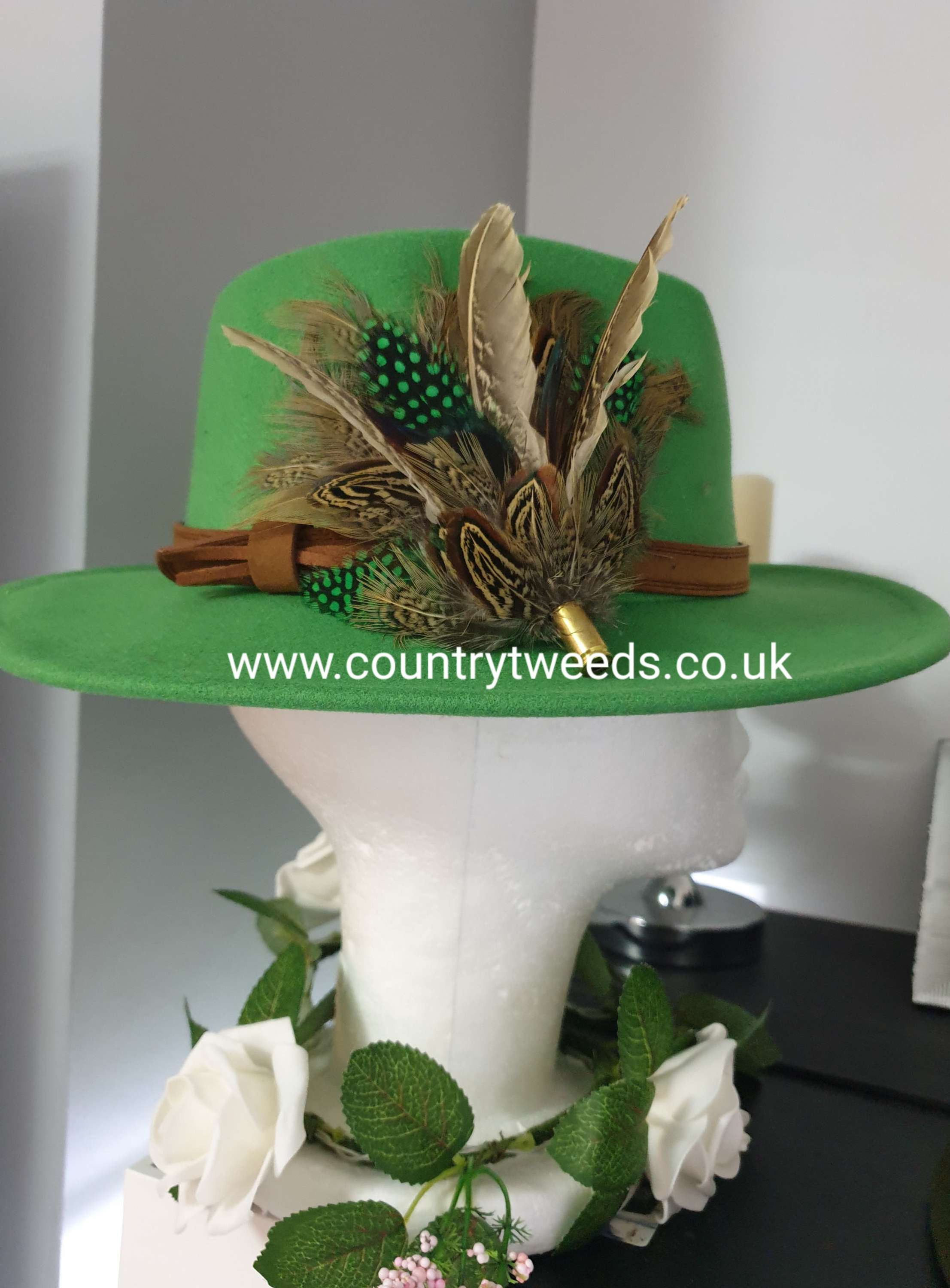Green fedora with matching feather brooch