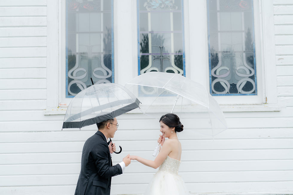a beautiful couple getting married in the rain holding umbrellas in a wedding venue in richmond, bc