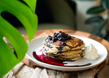 Finishing touches on a buttermilk blueberry pancake