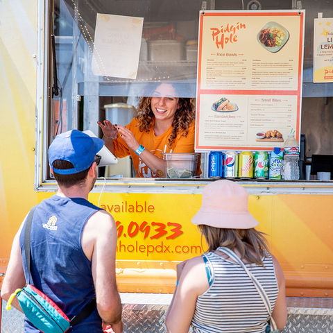 woman helping customers in food truck