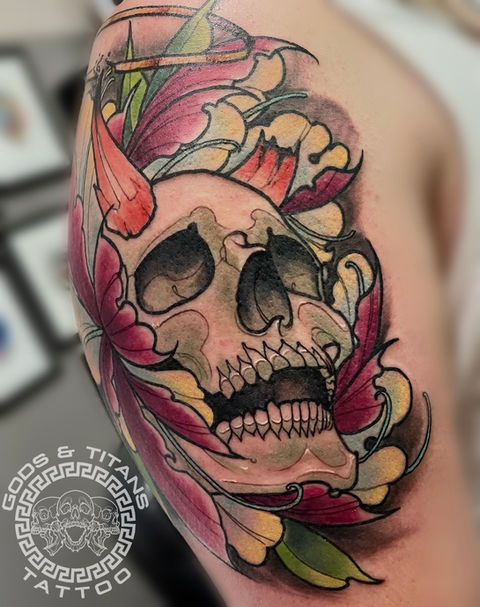 Skull resting within a peony, designed in neo traditional style. The peony is a magenta color, with highlights of a pale yellow and blue.