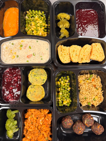 Four preschooler meals with vegetables and proteins in trays