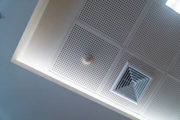 Shot of a smoke detector and ventilation duct