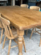 Handmade reclaimed oak farmhouse table in a workshop just made end leg view