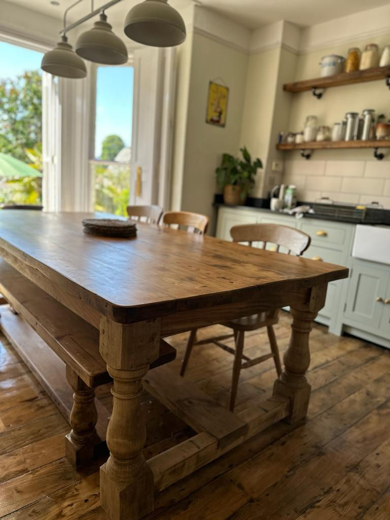handmade reclaimed pine refectory table in a country kitchen on a wooden floor th matching handmade bench seat.