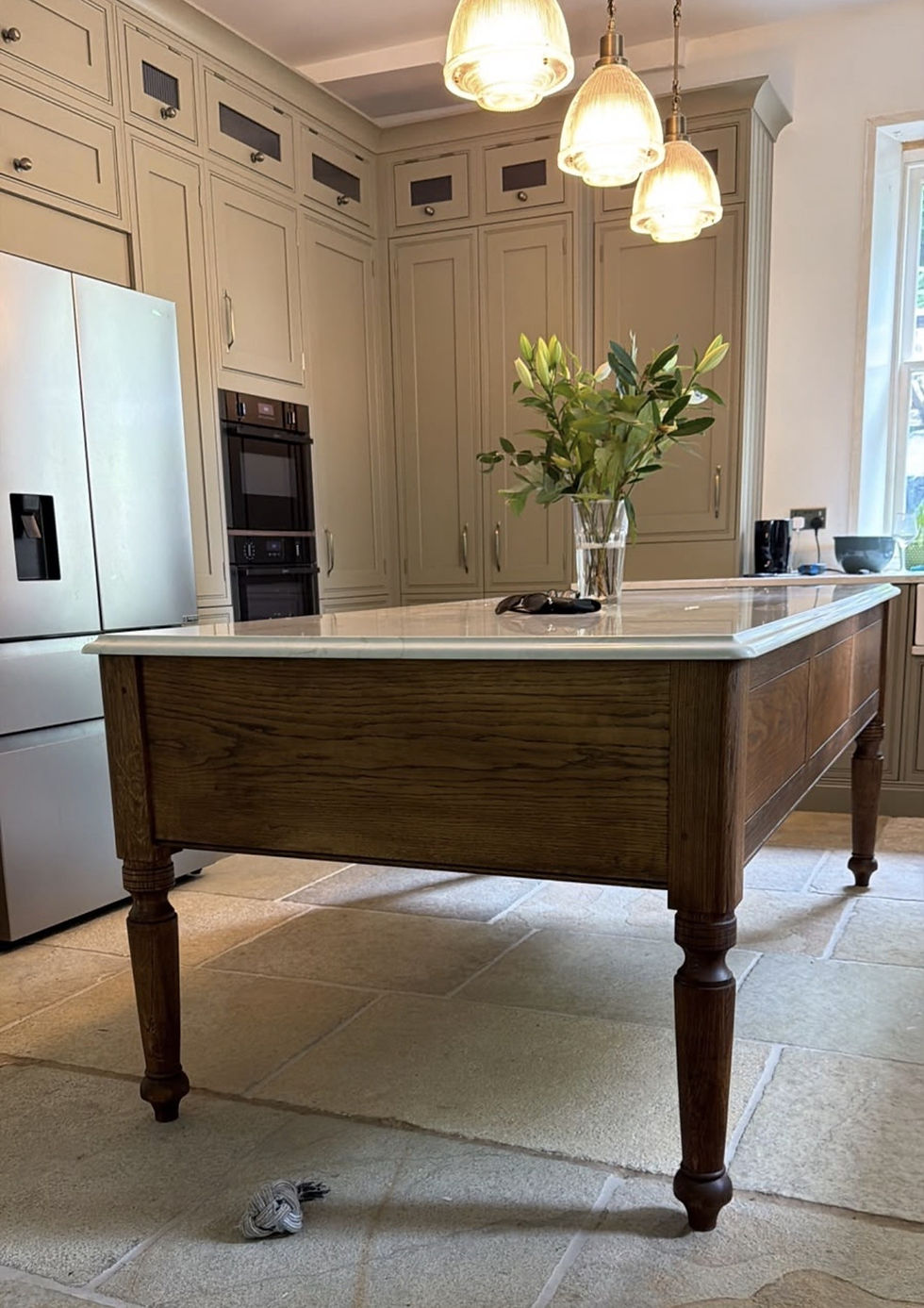 UK Handmade Oak Kitchen Island with vase of flowers in kitchen