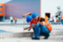 Construction Workers Measuring
