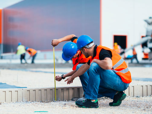 Construction workers measuring on job site — LiDAR vs manual measuring comparison